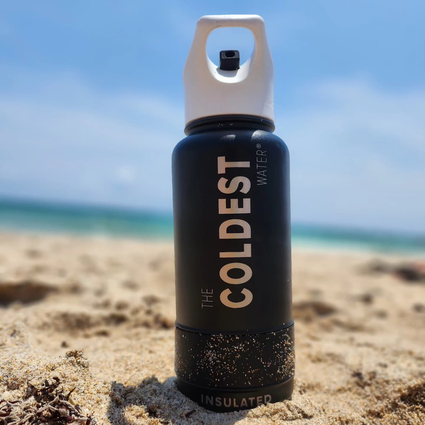 Black Coldest bottle in the sand